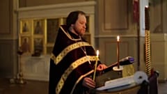 Orthodox priest conducting church service in Moscow for online worshippers