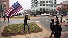 A man approaches the Capitol Building during Operation Gridlock, a protest against aspects of Gov. Whitmer's lockdown order, in Lansing, Michigan, Wednesday, April 15, 2020.