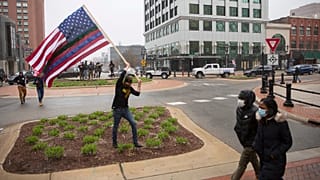 A man approaches the Capitol Building during Operation Gridlock, a protest against aspects of Gov. Whitmer's lockdown order, in Lansing, Michigan, Wednesday, April 15, 2020.