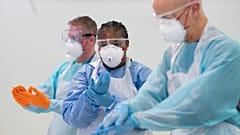 Staff receive training on how to put on and remove PPE, personal protective equipment against the coronavirus, Nightingale Hospital North West, Manchester, UK, April 16, 2020 