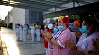 Health workers applaud medical staff working at the Puerta de Hierro hospital in Majadahonda, Spain, Saturday, April 18, 2020 