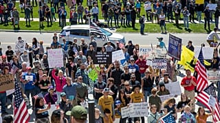 Several hundred people attend a "Stand for Freedom" rally against - and in violation of - a stay-at-home locidown order in Boise, Idaho, Friday, April 17, 2020. 