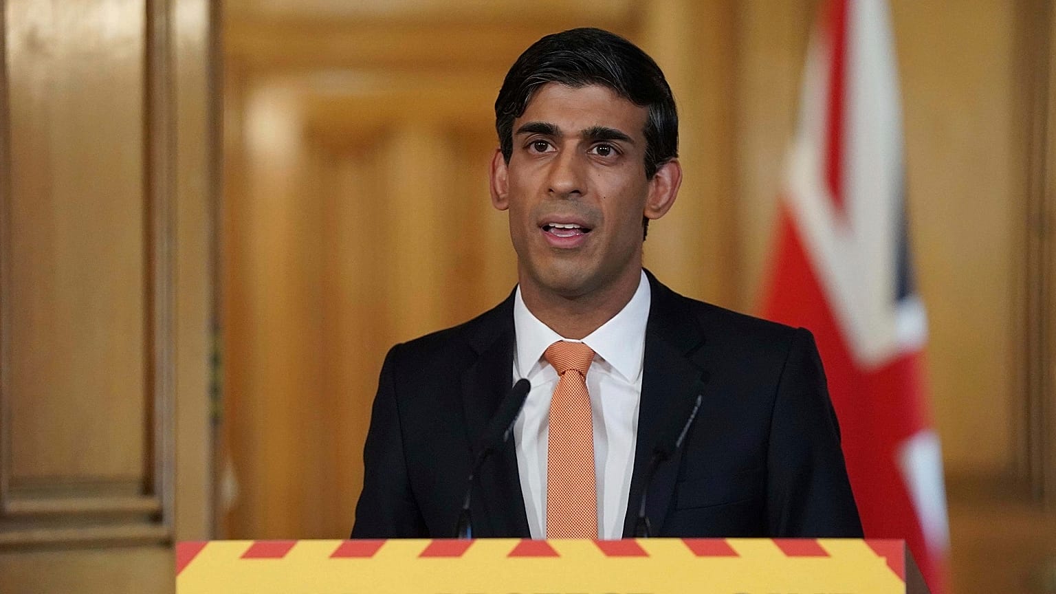 In this handout photo provided by 10 Downing Street, Britain's Chancellor Rishi Sunak speaks during a media briefing on the coronavirus outbreak in Downing Street, London