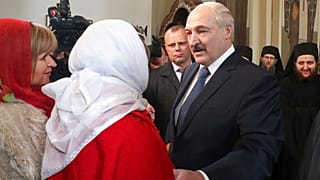 Belarusian President Alexander Lukashenko talks with believers during the Orthodox Easter service at a church in a village on the outskirts of Minsk