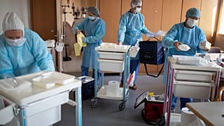 Medical staff from a private laboratory arrive to test the residents at a nursing home in Kaysesberg, France Thursday April 16, 2020.