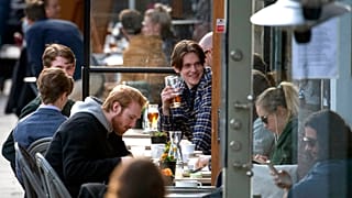 People enjoy themselves at an outdoor restaurant, amid the coronavirus outbreak, in central Stockholm, Sweden