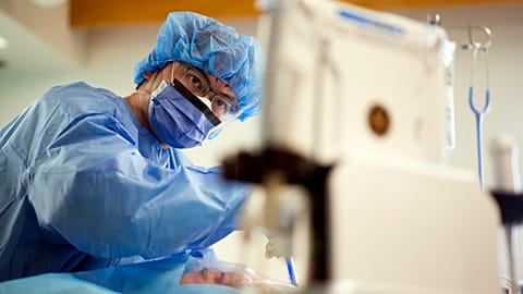 A doctor performs surgery in Canada in April 2020.