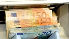In this June 22, 2009 file picture a machine counts Euro bank notes in a counter of a bank in Dresden, Germany