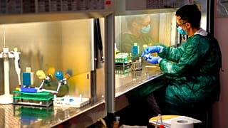 A technician works in the lab of the COVID-19 department of the Policlinic of Tor Vergata in Rome, Friday, April 17, 2020.