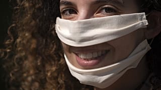 French Anissa Mekrabech, wearing the protective face mask she created for the deaf earing-impaired people