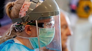 A nurse wears protective gear at Wren Hall nursing home in the central England village of Selston. 