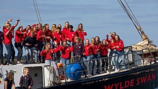 Dutch teens cheer after arriving home in Harlingen on April 26 following a trans-Atlantic forced on them by lockdown restrictions.