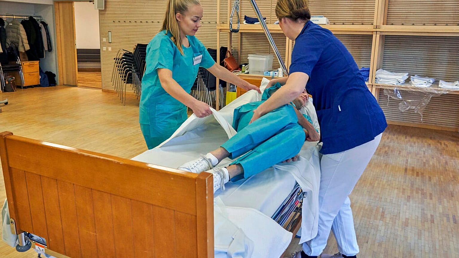 Former Scandinavian Airlines flight attendants learn basic skills on to assist in nursing homes and hospitals, Stockholm, Wednesday, April 1, 2020.