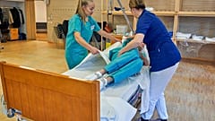Former Scandinavian Airlines flight attendants learn basic skills on to assist in nursing homes and hospitals, Stockholm, Wednesday, April 1, 2020.
