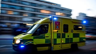An ambulance drives past St Thomas' Hospital in central London on April 7, 2020.