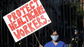 An NHS doctor protests in front of Downing Street on April 19, 2020