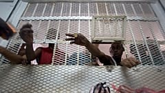 Several inmates buy supplies at Najayo jail's store in San Cristobal, May 30, 2007.