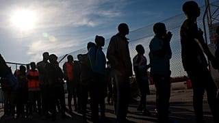 A group of migrants disembark from a vessel after being rescued by Spanish maritime authorities at Motril port in Granada, Spain