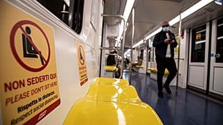 "Respect social distancing" reads a sign on Milan's metro.