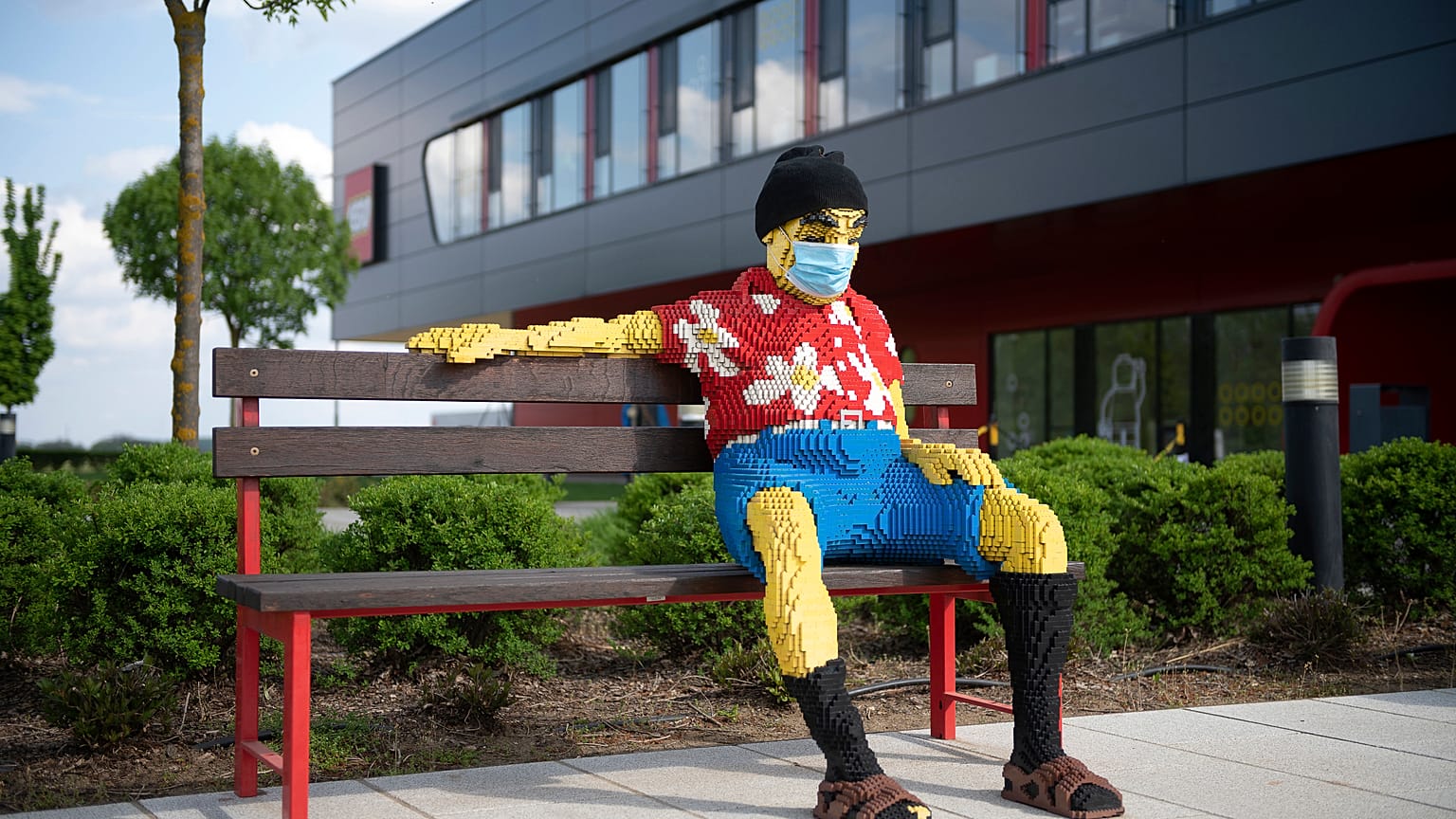 Padon ülő figura maszkban a nyíregyházi Lego-gyár előtt