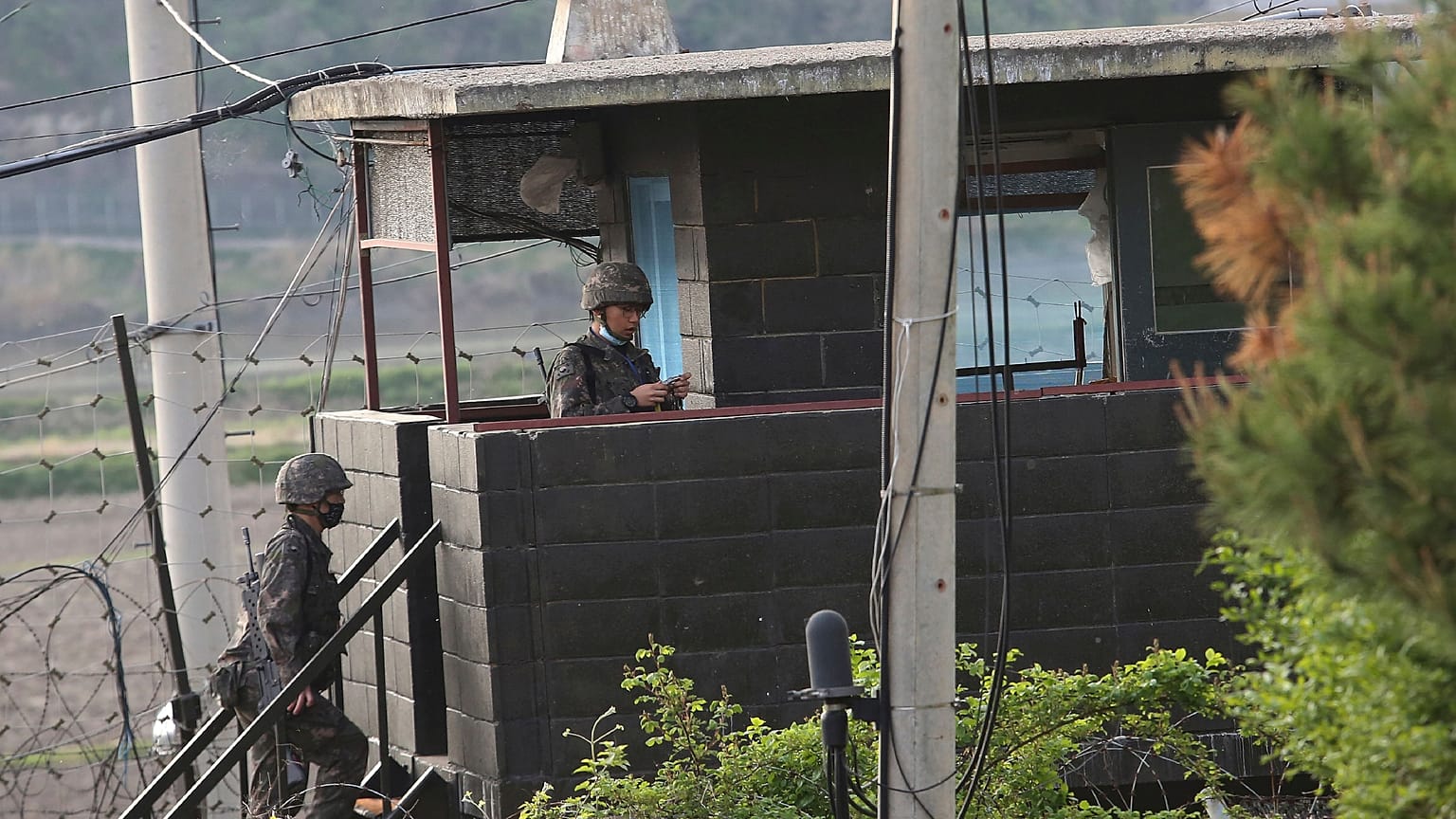 Army soldiers walk up the stairs of their military guard post in Paju, South Korea
