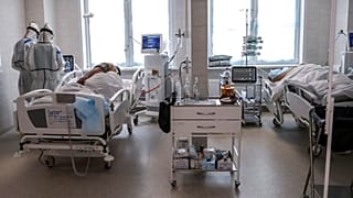 Doctors attend to a patient inside the intensive care unit for people infected with the new coronavirus, at a hospital in Moscow, Russia, May 2, 2020.