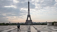 A man wears a mask to protect against the spread of the coronavirus as he walks along the Trocadero square close to the Eiffel Tower in Paris