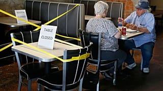 Tables are taped off to promote social distancing at Falcone's Pizzeria in Oklahoma City, as restaurants are allowed to open for in person dining