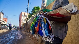 A street vendor sells material masks as a preventive measure against the spread of the COVID-19