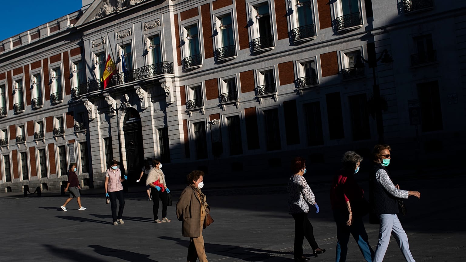 People wearing face masks to combat the spread of coronavirus continues walk at Sol square in Madrid, Spain,