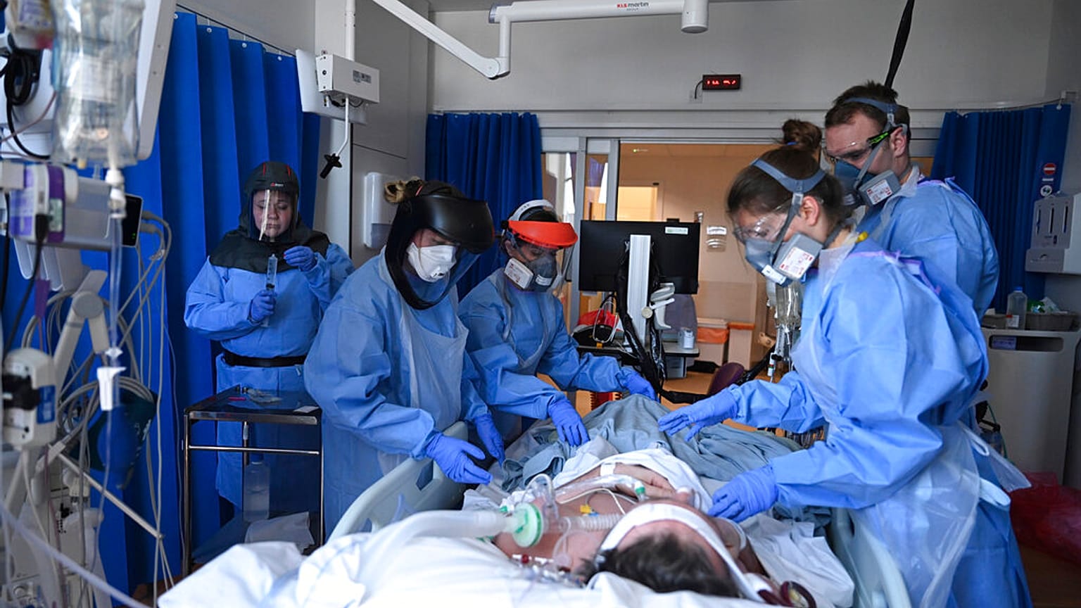 Members of clinical staff care for a patient with coronavirus in the intensive care unit at the Royal Papworth Hospital in Cambridge, UK, Tuesday May 5, 2020