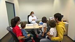 Family in testing room at Schwechat Airport, Austria