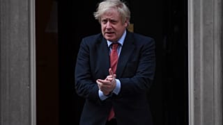 Britain's Prime Minister Boris Johnson joins in the applause on the doorstep of 10 Downing Street in London during the weekly "Clap for our Carers" Thursday, May 7, 2020.