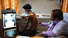 File, 2014 - a doctor examines a tuberculosis patient in a government TB hospital in Allahabad, India