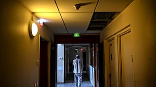 A patient walks in a corridor of the Clos Benard psychiatric hospital in Aubervilliers,