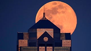 Last month's supermoon rising behind a downtown office building in Kansas City, Mo., Tuesday, April 7, 2020.