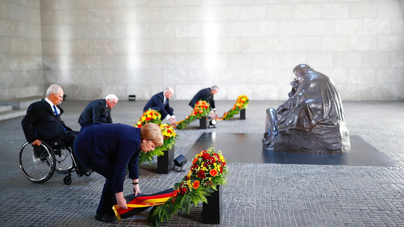 German Chancellor Angela Merkel and other officials lay wreaths at the Neue Wache Memorial in Berlin, Germany, May 8, 2020. 