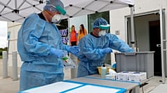 In this April 2, 2020, file photo, nurses set up a COVID-19 testing station for pre-screened pediatric patients.