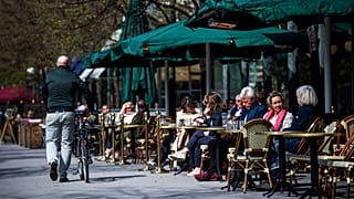 People sit in a restaurant in Stockholm on May 8, 2020, amid the coronavirus COVID-19 pandemic. (Photo by Jonathan NACKSTRAND / AFP)