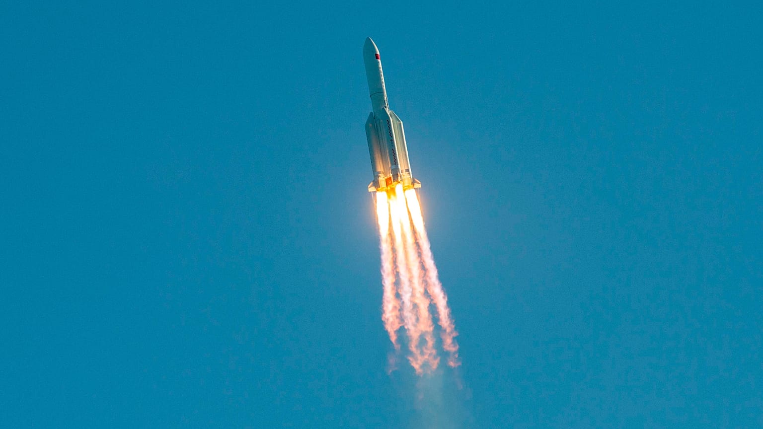 (FILES) This file photo taken on May 5, 2020 shows a Long March 5B rocket lifting off from the Wenchang launch site on China's southern Hainan island. 