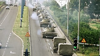 Tanks and jeeps of the Yugoslav Army cross a bridge on way back to the Marshal-Tito-Barracks in Zagreb on Wednesday, July 3, 1991.