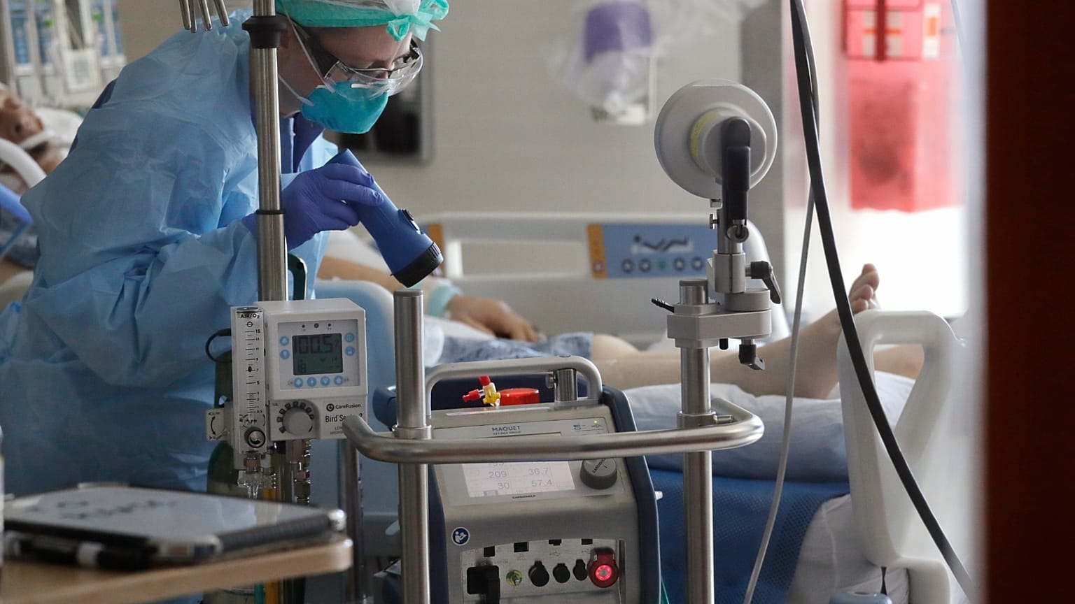 A nurse monitors a machine machine connected to a patient in the COVID-19 Intensive Care Unit at Harborview Medical Center Friday, May 8, 2020, in Seattle. 