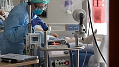 A nurse monitors a machine machine connected to a patient in the COVID-19 Intensive Care Unit at Harborview Medical Center Friday, May 8, 2020, in Seattle. 