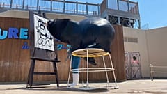 Un león marino dibuja, pincel en boca, un monstruo mitológico que protege de las plagas
