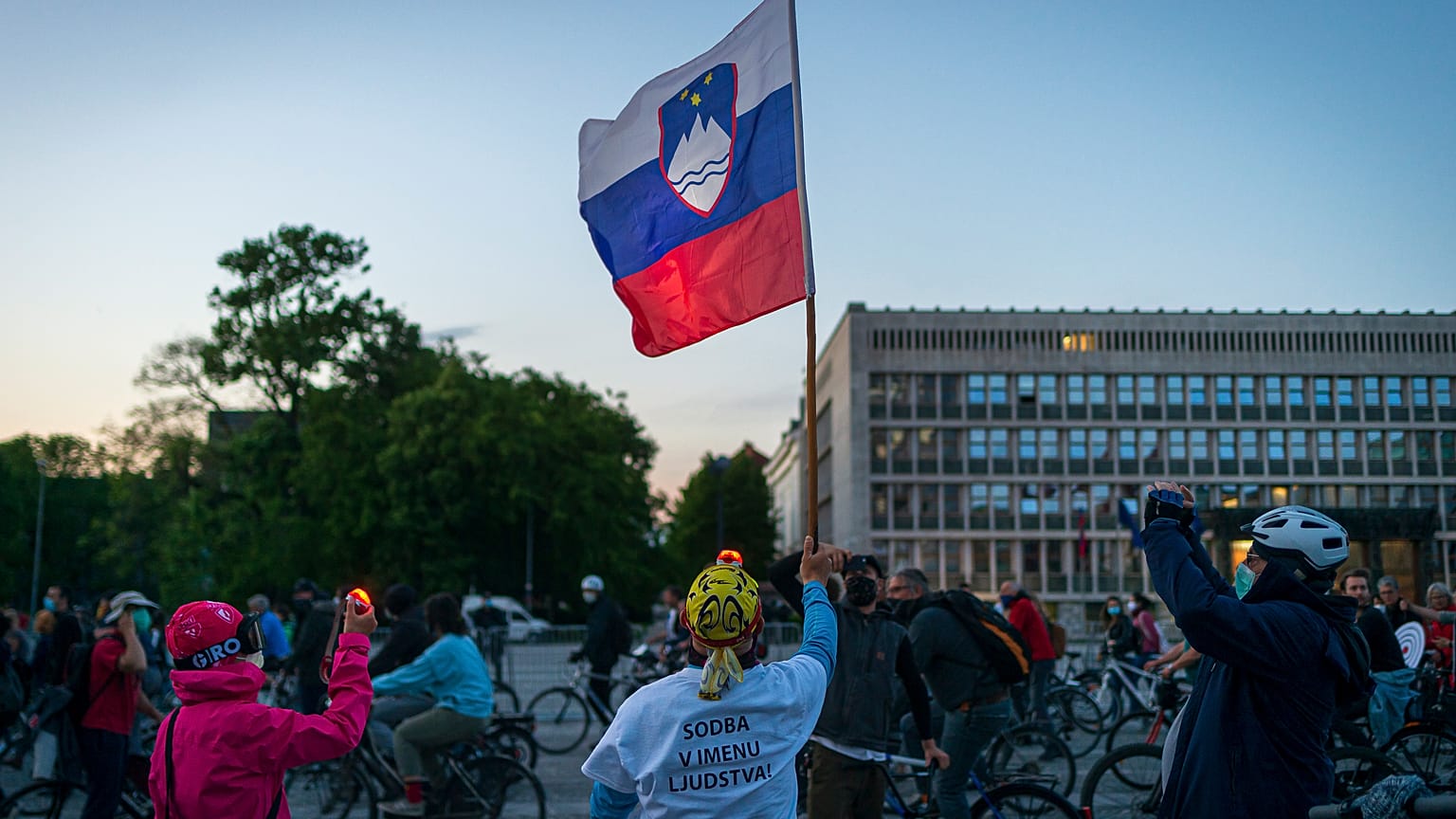 A man holds a Slovenian flag 