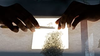 A worker sorts diamonds according their color (AP Photo/Themba Hadebe)