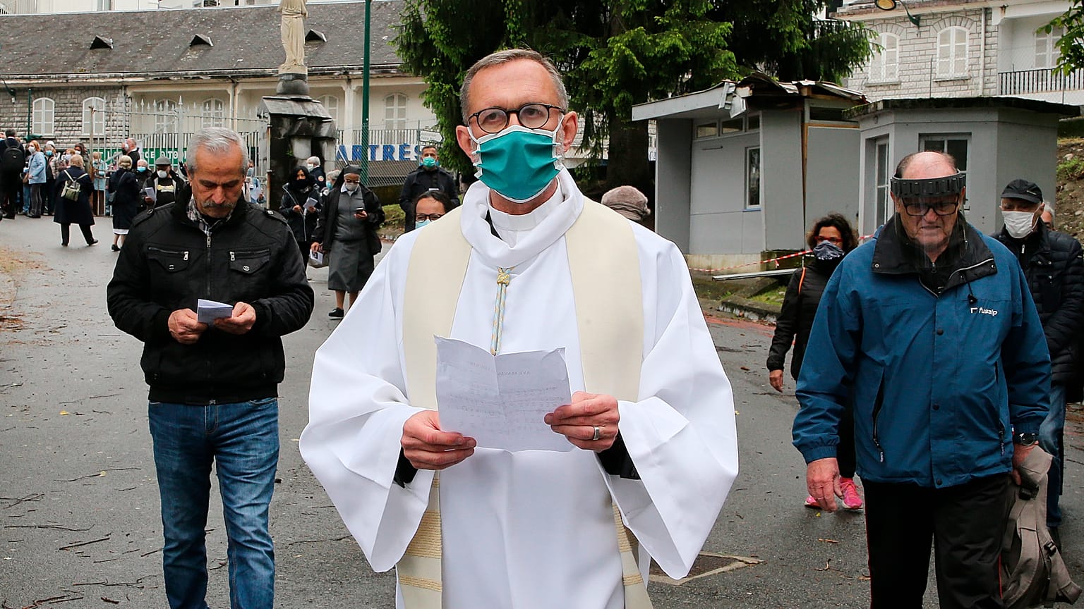 Olivier Ribadeau Dumas accompanies the first pilgrims into the Lourdes Roman Catholic sanctuary, in southwestern France, Saturday, May 16, 2020