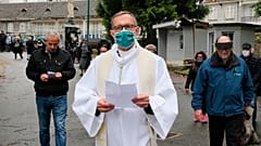 Olivier Ribadeau Dumas accompanies the first pilgrims into the Lourdes Roman Catholic sanctuary, in southwestern France, Saturday, May 16, 2020