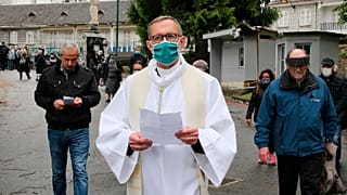 Olivier Ribadeau Dumas accompanies the first pilgrims into the Lourdes Roman Catholic sanctuary, in southwestern France, Saturday, May 16, 2020
