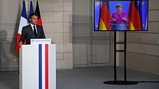 French President Emmanuel Macron listens to German Chancellor Angela Merkel during a joint video press conference Monday, May 18, 2020 in Paris. (AP/Francois Mori, Pool)